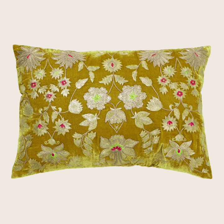 Rectangular plush green pillow with intricate metallic floral design.