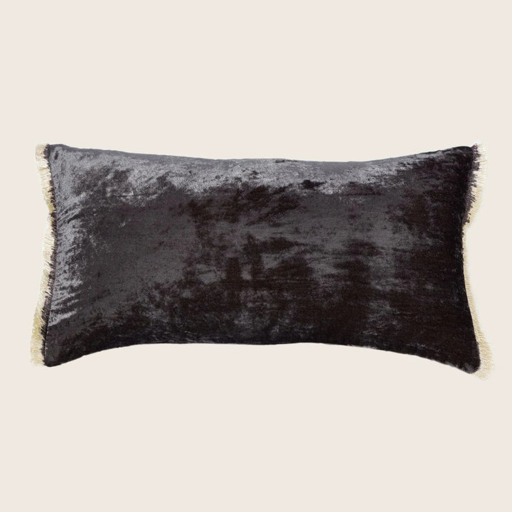 Rectangular cushion with velvety texture and elegant fringe trim.