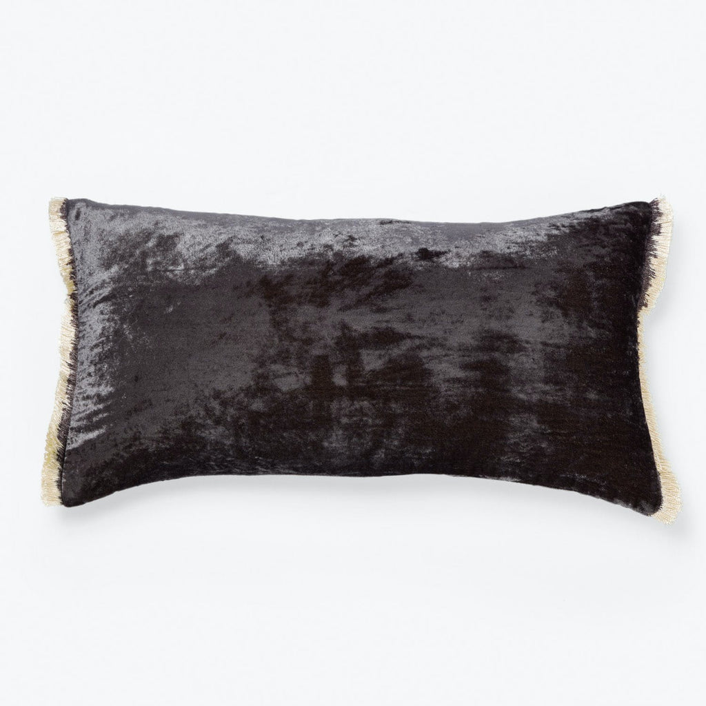 Rectangular cushion with velvety texture and elegant fringe trim.