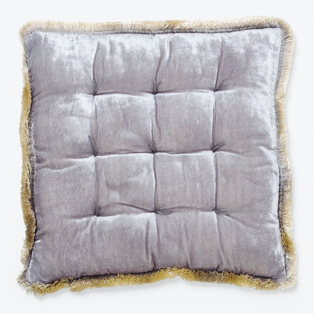Square decorative pillow with tufted design and fringe detail.
