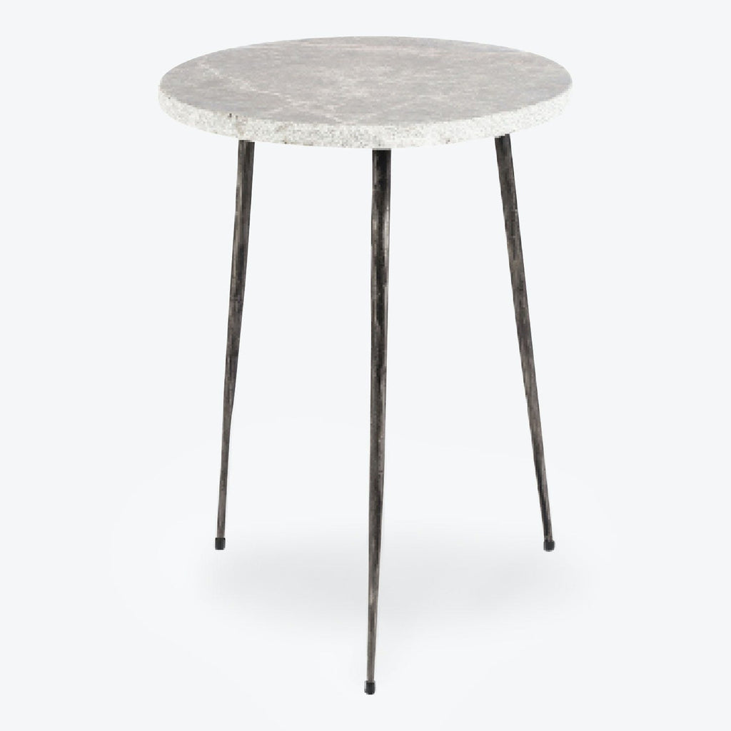 Modern round table with stone-look top and sleek metal legs.