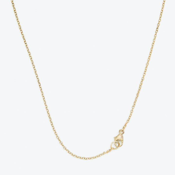 Close-up of a gold necklace with a spring ring clasp.