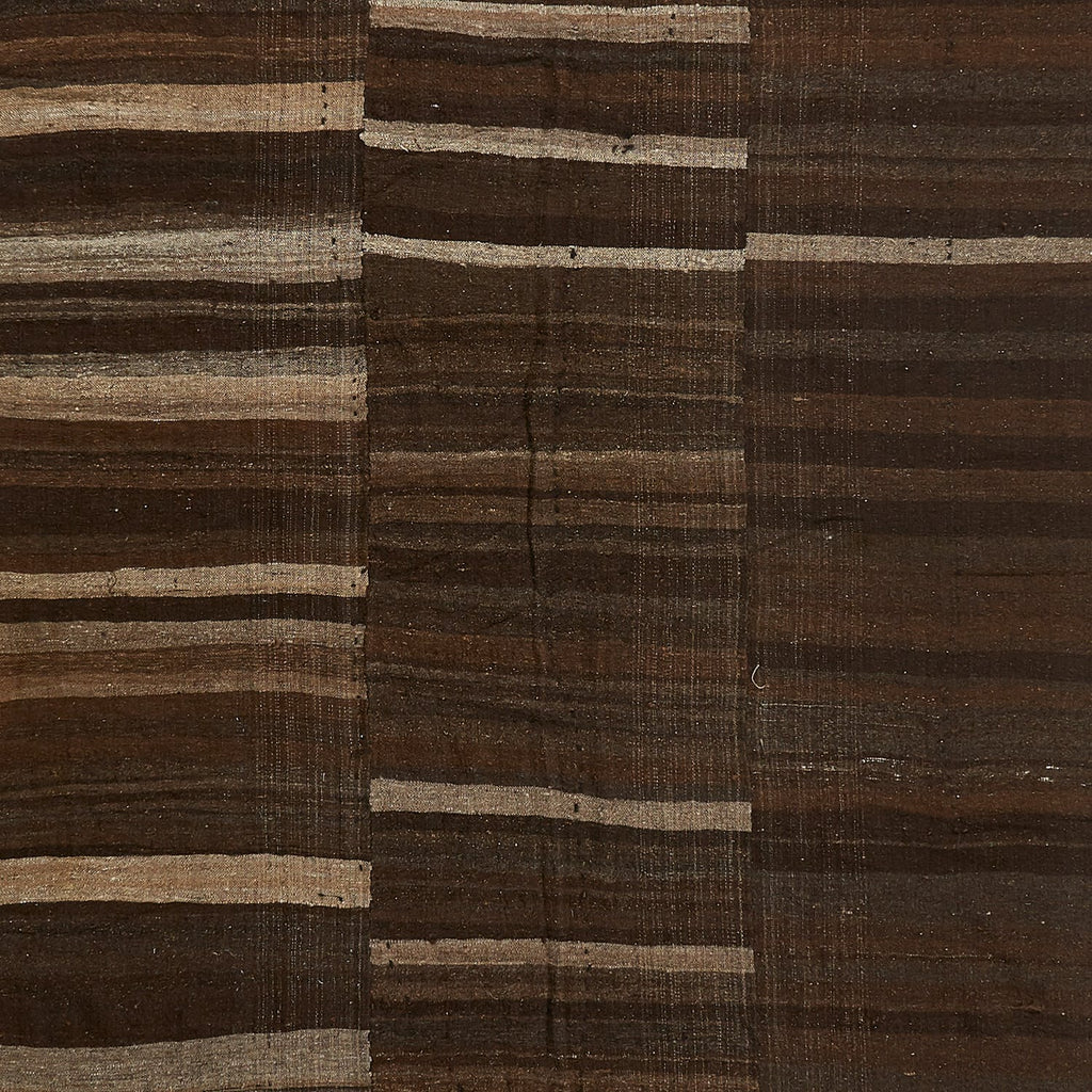Close-up of a dark brown fabric with horizontal beige stripes.