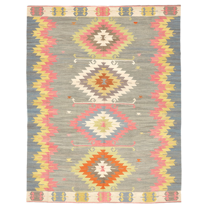 Vibrant tribal rug with symmetrical diamond patterns in muted background.
