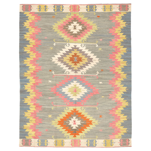 Vibrant tribal rug with symmetrical diamond patterns in muted background.