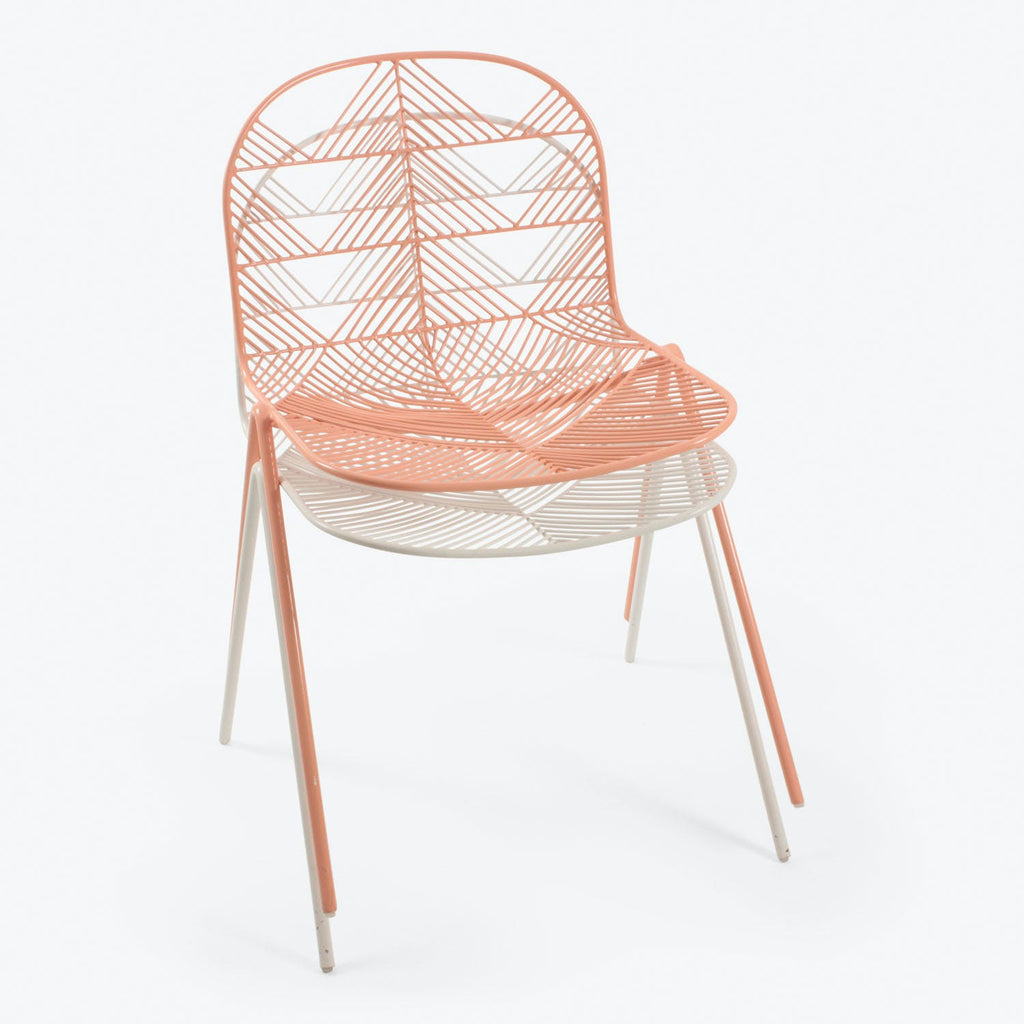 Contemporary coral and white chair with geometric net-like design.