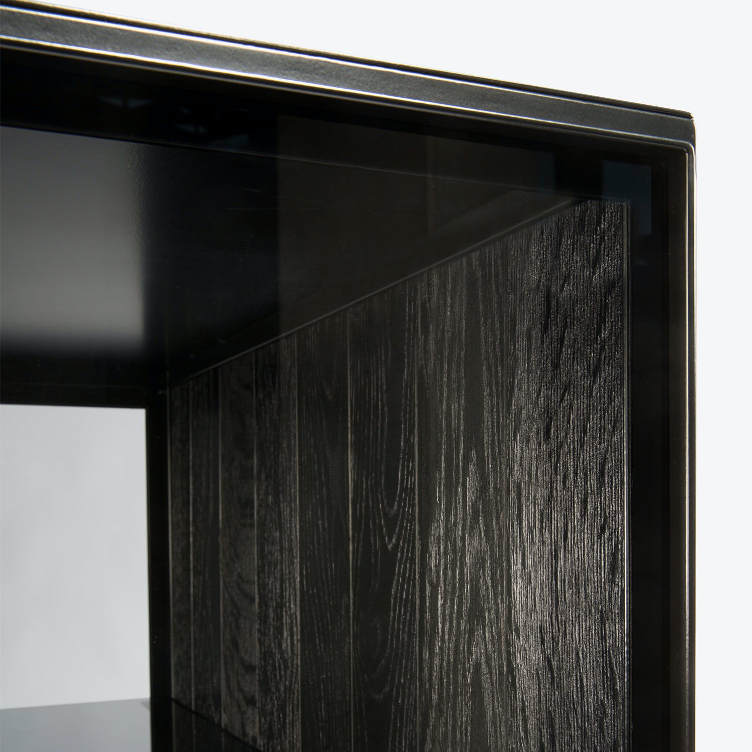 Close-up view of a black wooden frame with glass insert.