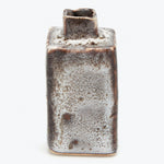 Handcrafted ceramic vase with gradient glaze finish against white background.