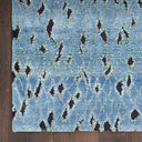 Vintage blue rug with geometric pattern on wooden floor