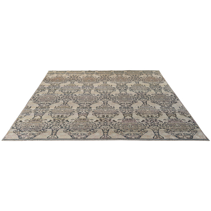 Elaborate symmetrical patterned rug with muted colors and solid border.