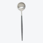 Elegant metal spoon with a brushed finish against white backdrop.