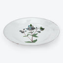 An elegant ceramic plate adorned with hand-painted floral motif.