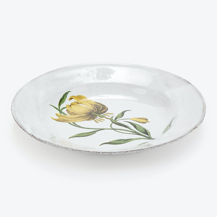 Handcrafted circular plate with a simple floral illustration centerpiece.