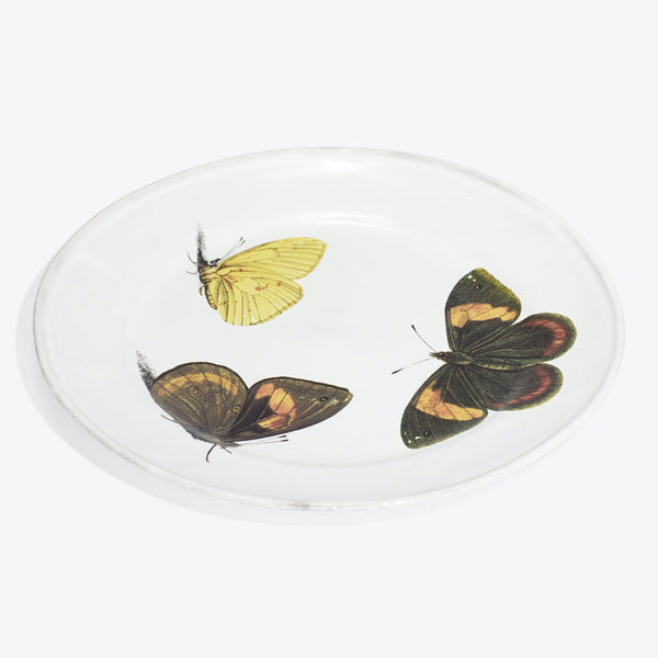 Round glass plate with intricately printed butterfly illustrations in vibrant colors.
