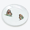 Vibrant butterfly illustrations on clear glass plate showcase intricate details.