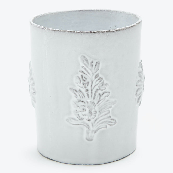 Handmade white ceramic container featuring botanical relief pattern for decoration.
