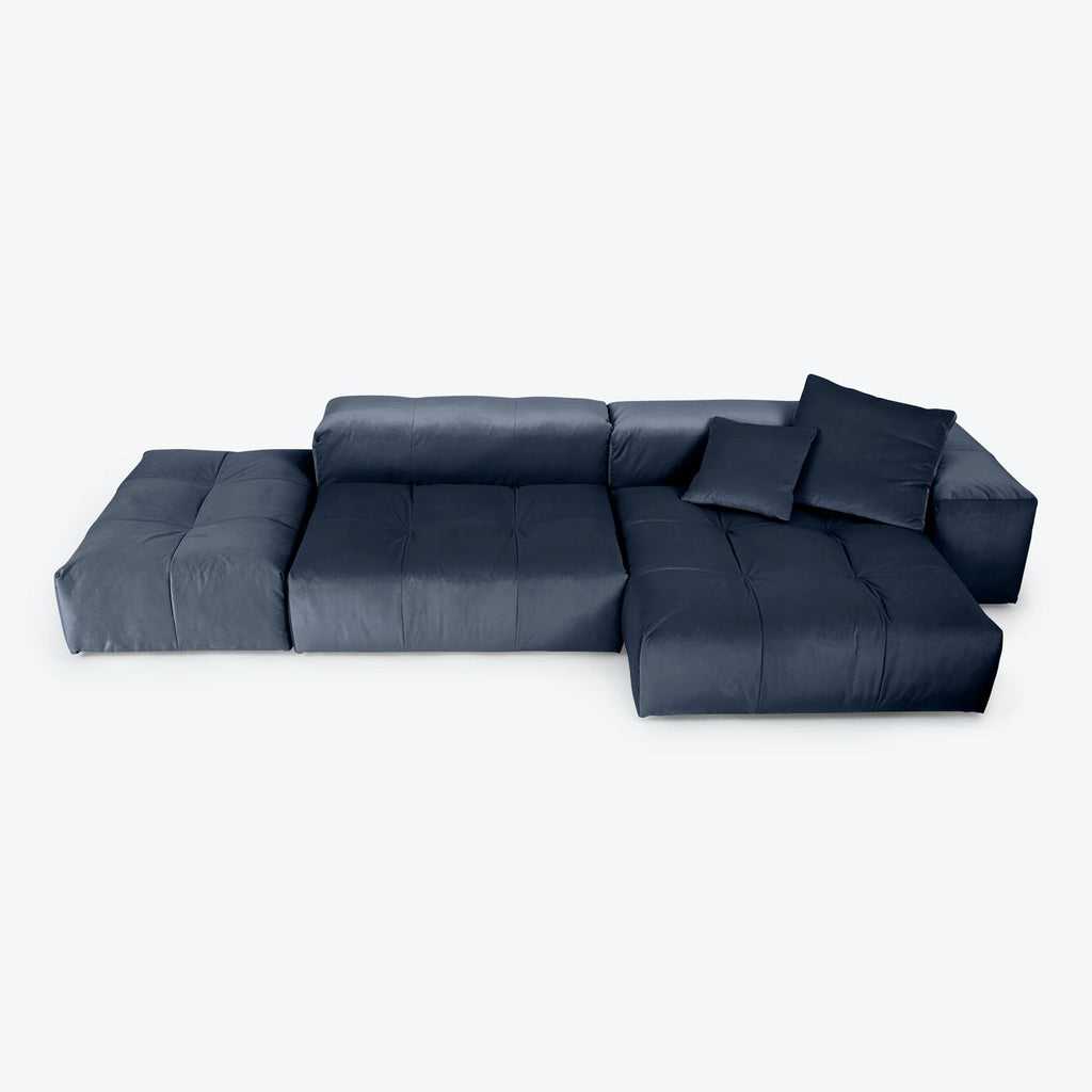 Contemporary navy modular sectional sofa with tufted cushions and throw pillows.