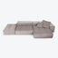 Contemporary and minimalist light gray sectional sofa with tufted cushions.