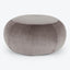 Symmetrical gray velvet pouf with visible vertical stitches on white background.