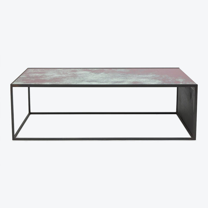 Minimalist rectangular coffee table with textured pink-gray tabletop and black frame.