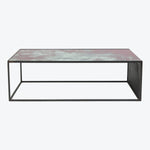 Minimalist rectangular coffee table with textured pink-gray tabletop and black frame.