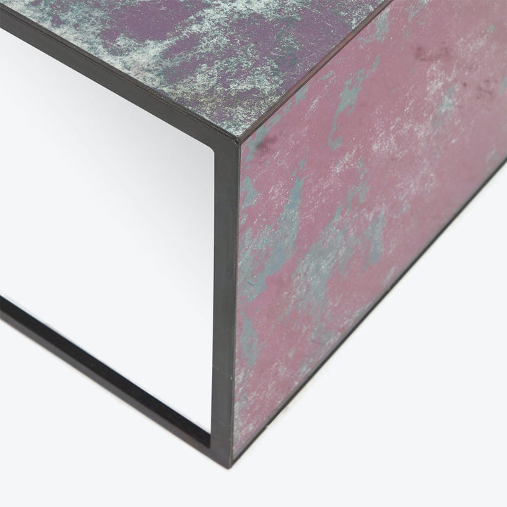 Close-up view of weathered metal object with peeling red paint