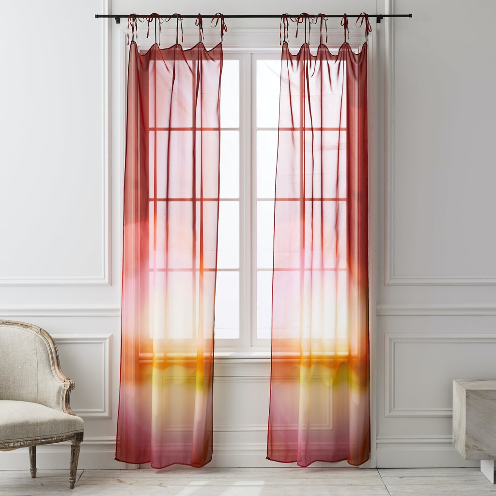 Translucent ombre curtains create a warm glow in a traditional interior.