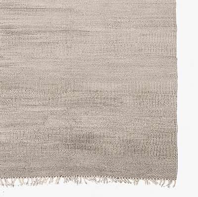 Minimalist woven textile with horizontal bands and fringe detail.