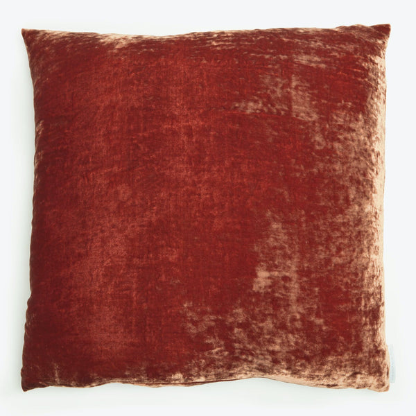 Rich red velvet square pillow adds luxury and comfort to furniture.