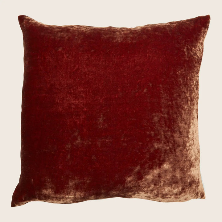 Square-shaped, plush red velvet pillow with a luxurious texture.