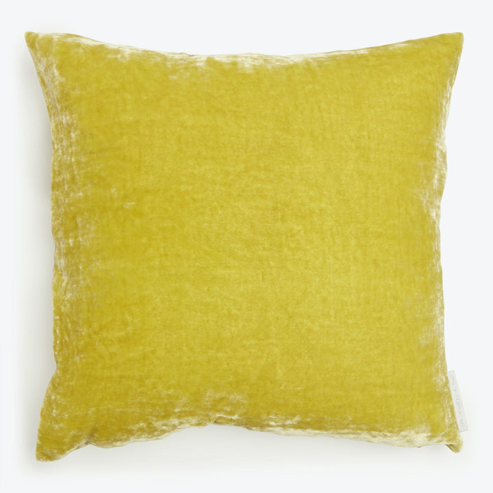 Vibrant yellow square pillow with plush texture and soft fabric.