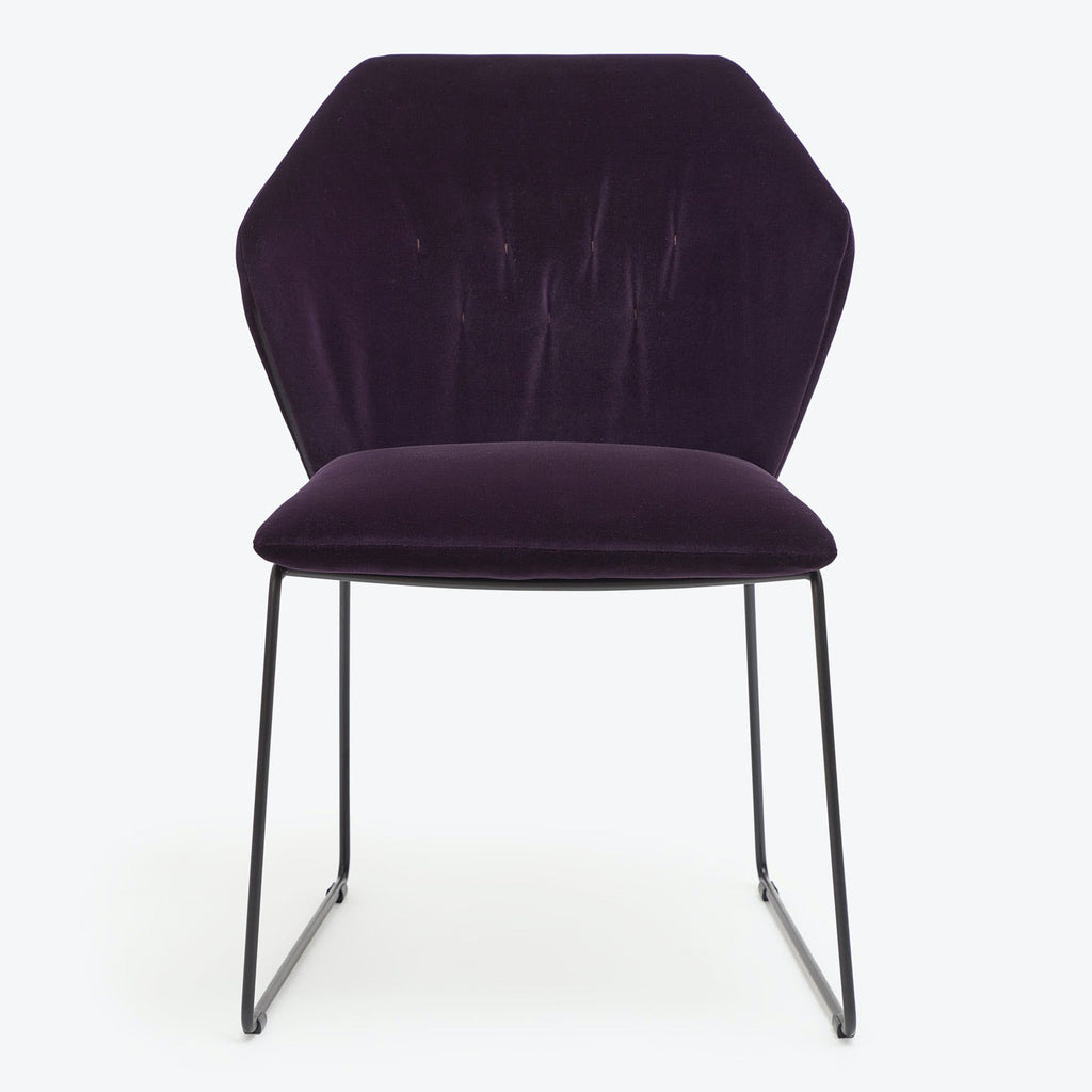 Contemporary elegance embodied in a plum-colored, velvet upholstered hexagonal chair.