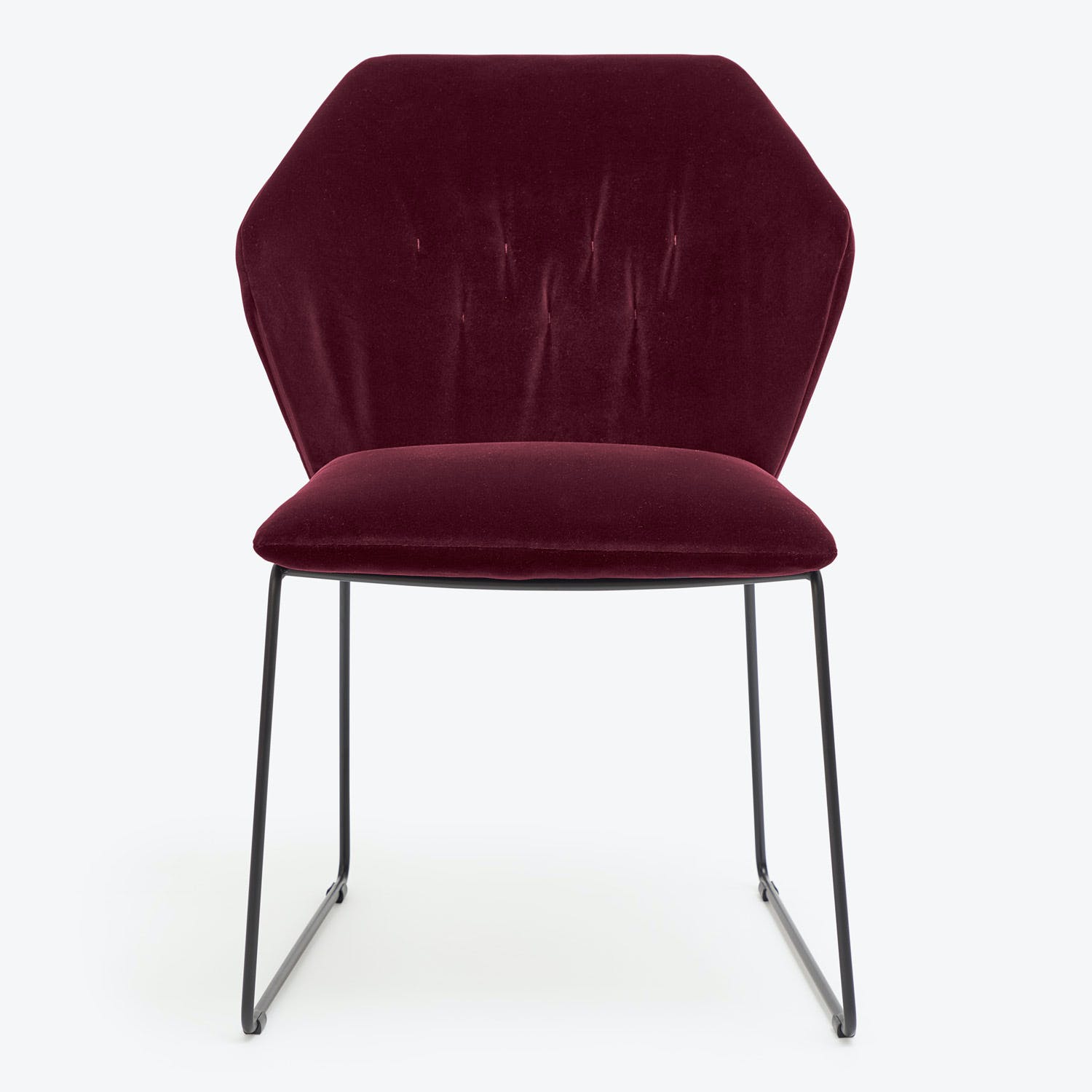 Minimalist burgundy chair with sleek metal legs offers modern elegance.