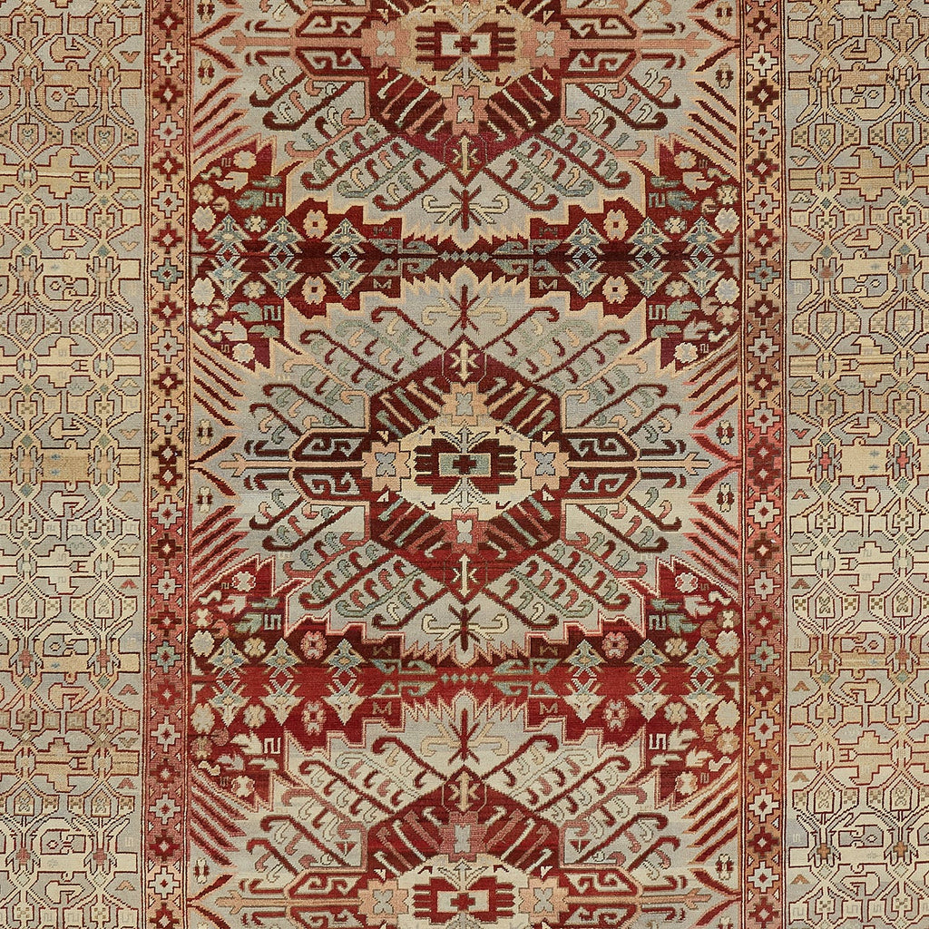 Exquisite hand-woven rug showcases intricate geometric and floral motifs.