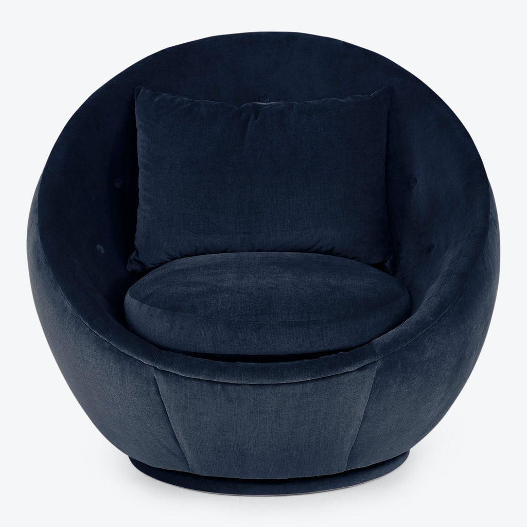 Contemporary navy blue armchair with plush velvet-like fabric and enveloping design.
