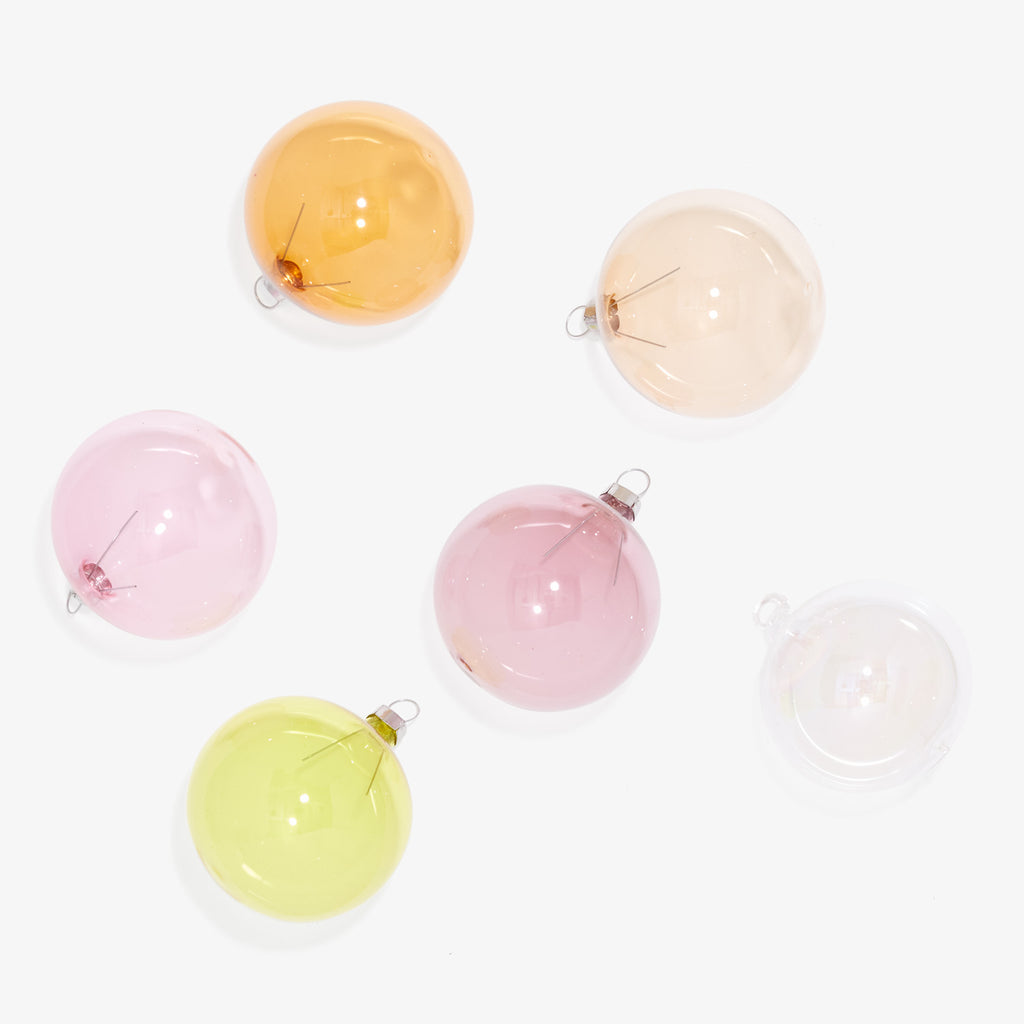 Six colorful glass baubles for festive decoration against white background.