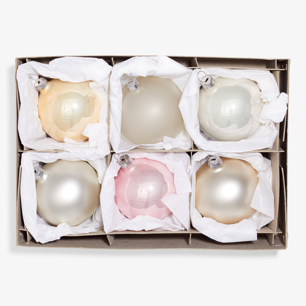 Six large Christmas ornaments packed in box with protective cushioning.