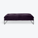 Plush purple ottoman with sleek metal frame exudes modern luxury.