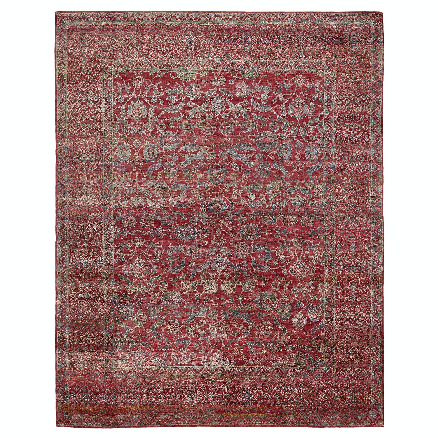 Intricate, symmetrical oriental carpet in rich reds and blues.