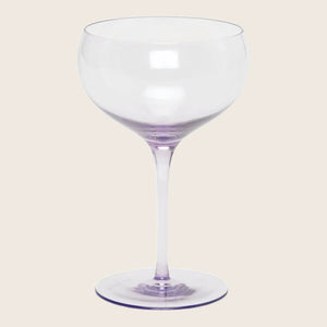 Empty red wine glass with elegant design against white background.