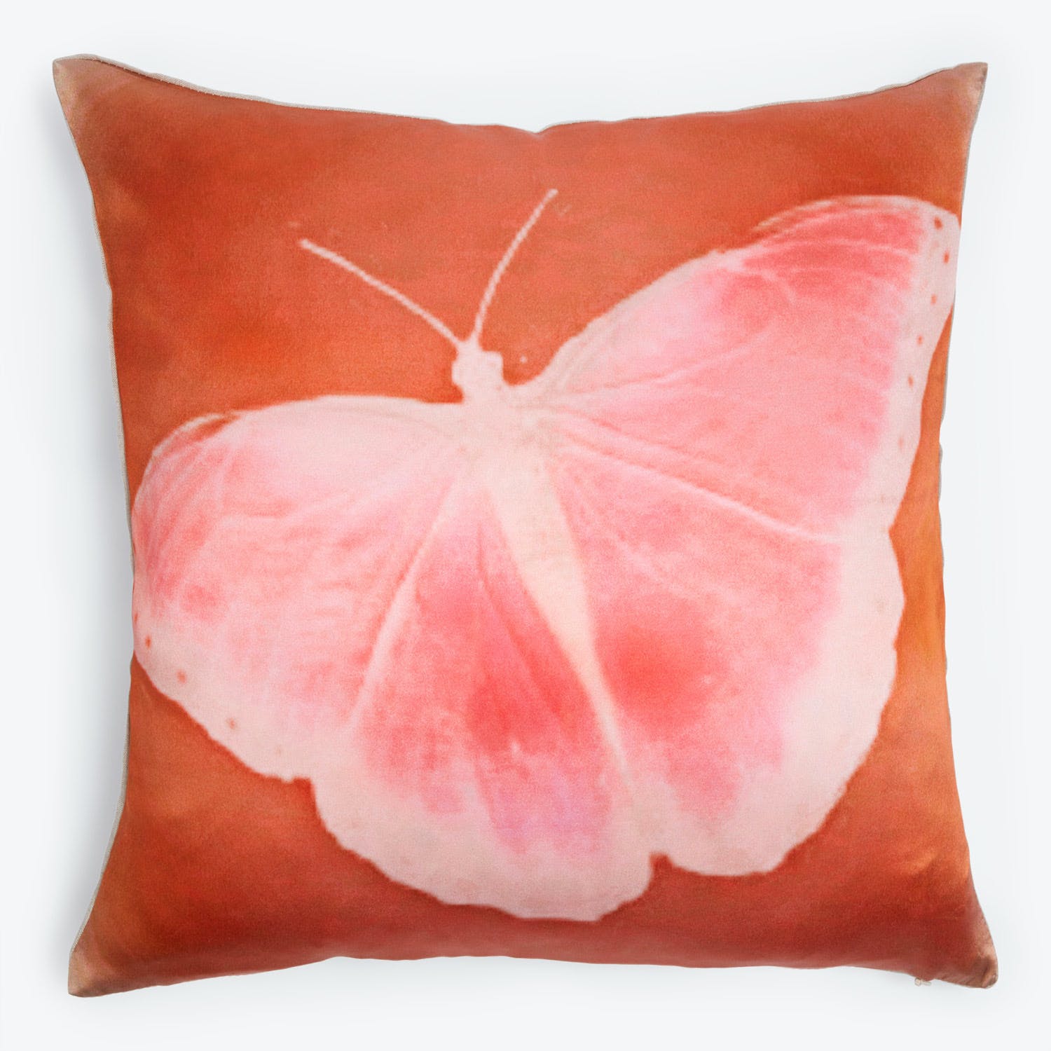 Square pillow adorned with a fading pink butterfly design.