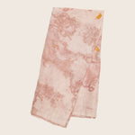 Uneven, splotchy pink fabric with darker blotches and yellow stains.
