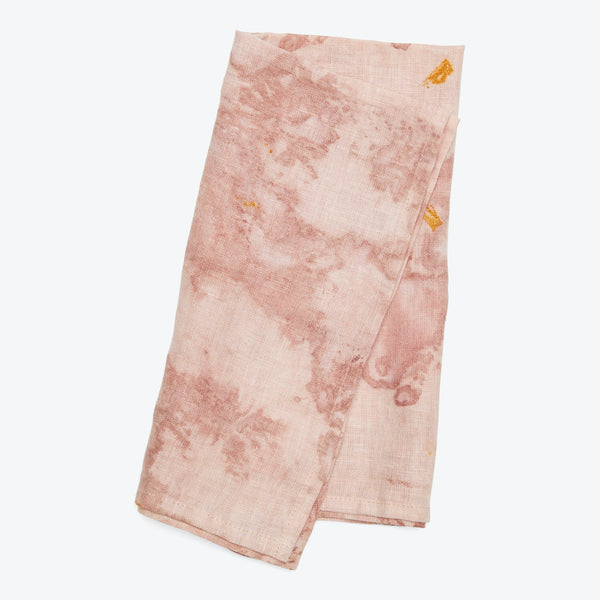 Uneven, splotchy pink fabric with darker blotches and yellow stains.