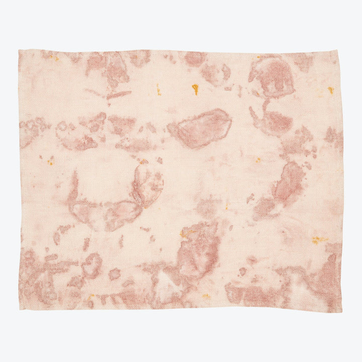 Close-up of a textured fabric with blotchy multicolored marks.