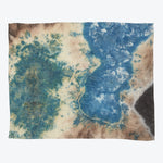 Rectangular tie-dye fabric showcasing a mix of blue and brown hues with hints of green and black.