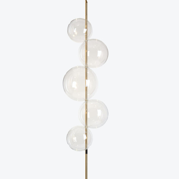 Modern vertical floor lamp with sleek glass globes emitting soft glow