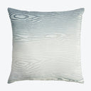 Square pillow with wood grain-like design in soft grays.