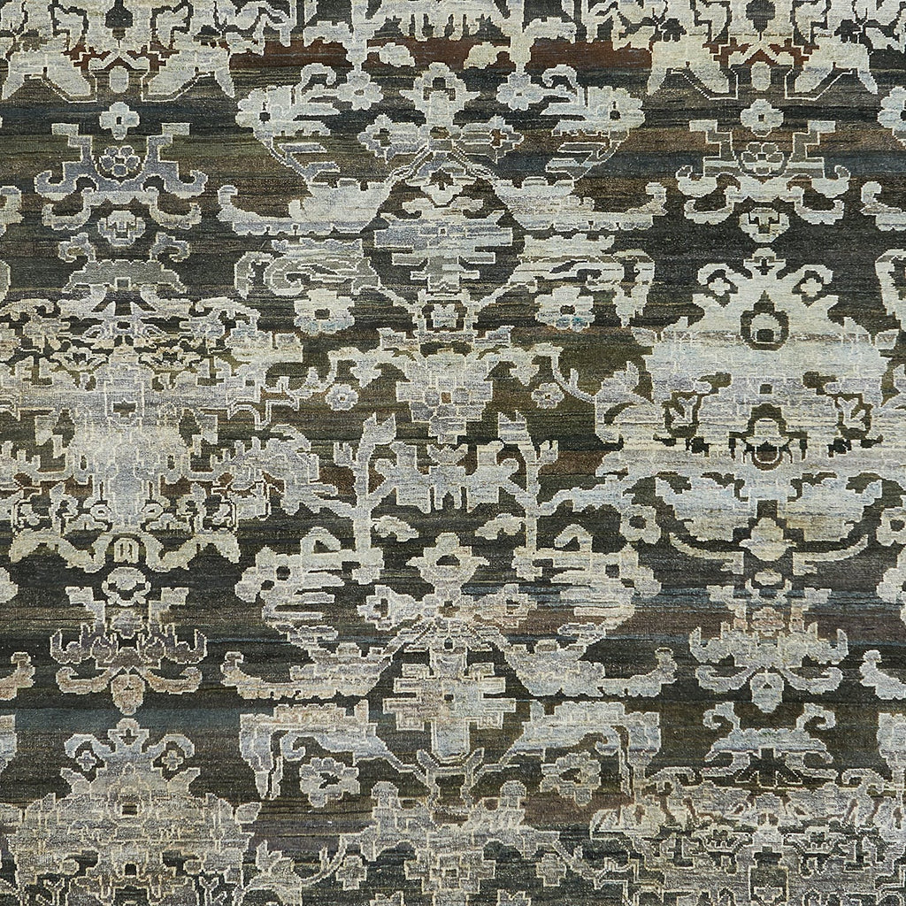 Intricate symmetrical motifs in vintage, faded hues on traditional carpet.