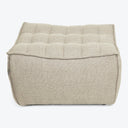 Neutral beige tufted fabric-upholstered ottoman with textured weave for sale.