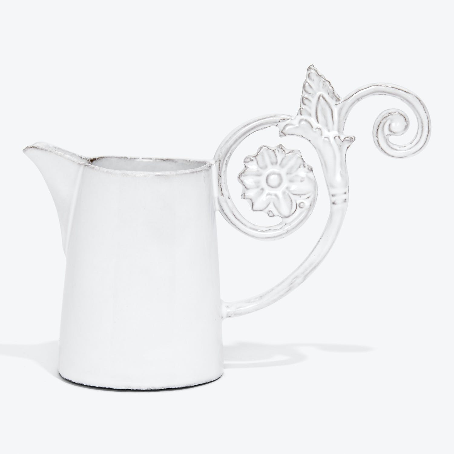 Elegant ceramic creamer jug with intricate handle and spout.